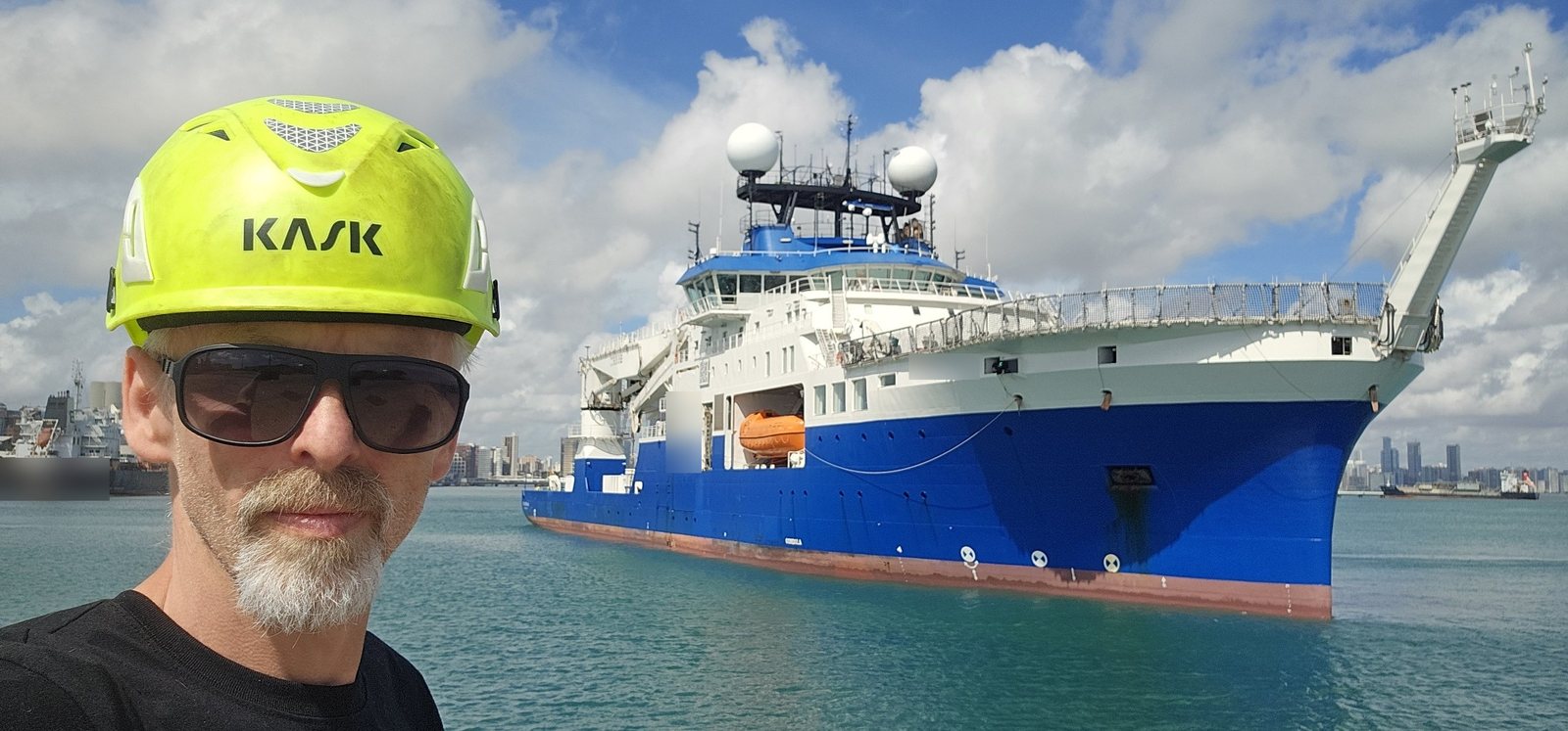 ME-Tech technician in front of a research vessel