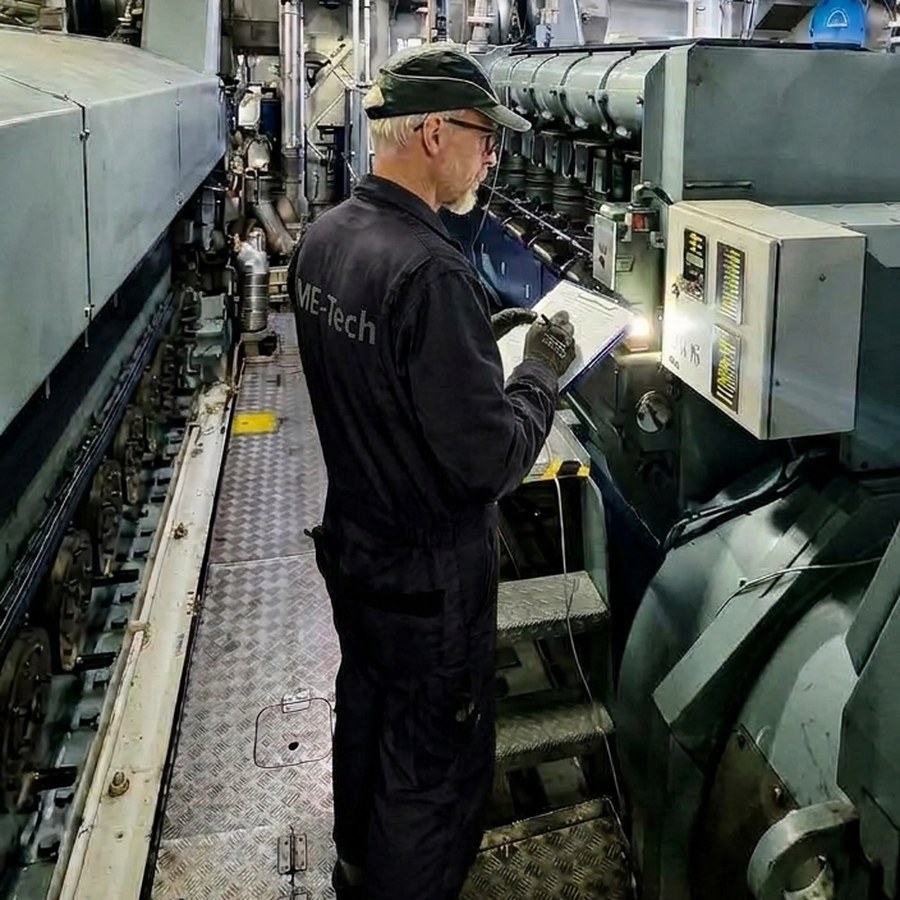 ME-Tech technician reading engine performance data in the engine room