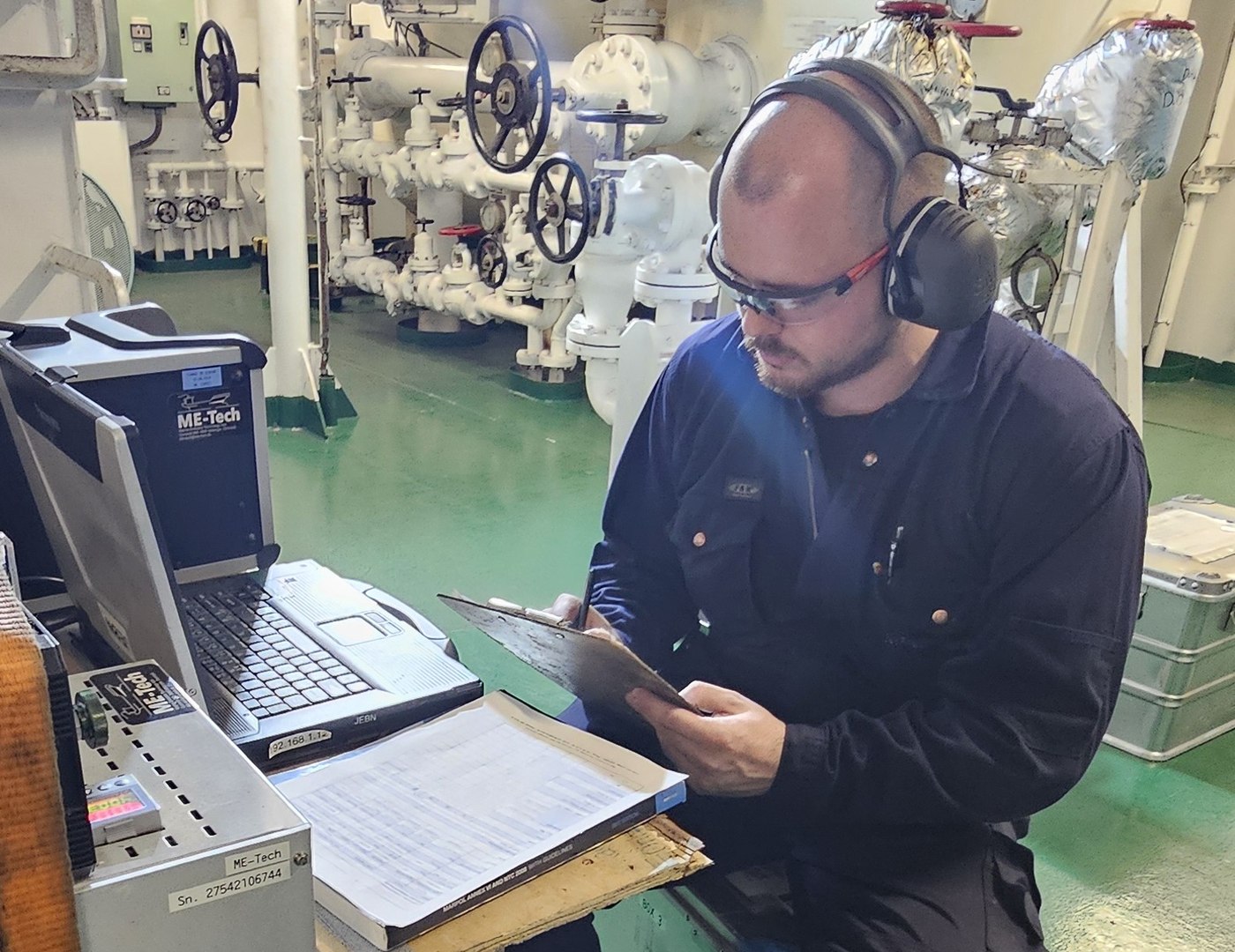 ME-Tech technician analysing engine performance in the engine room