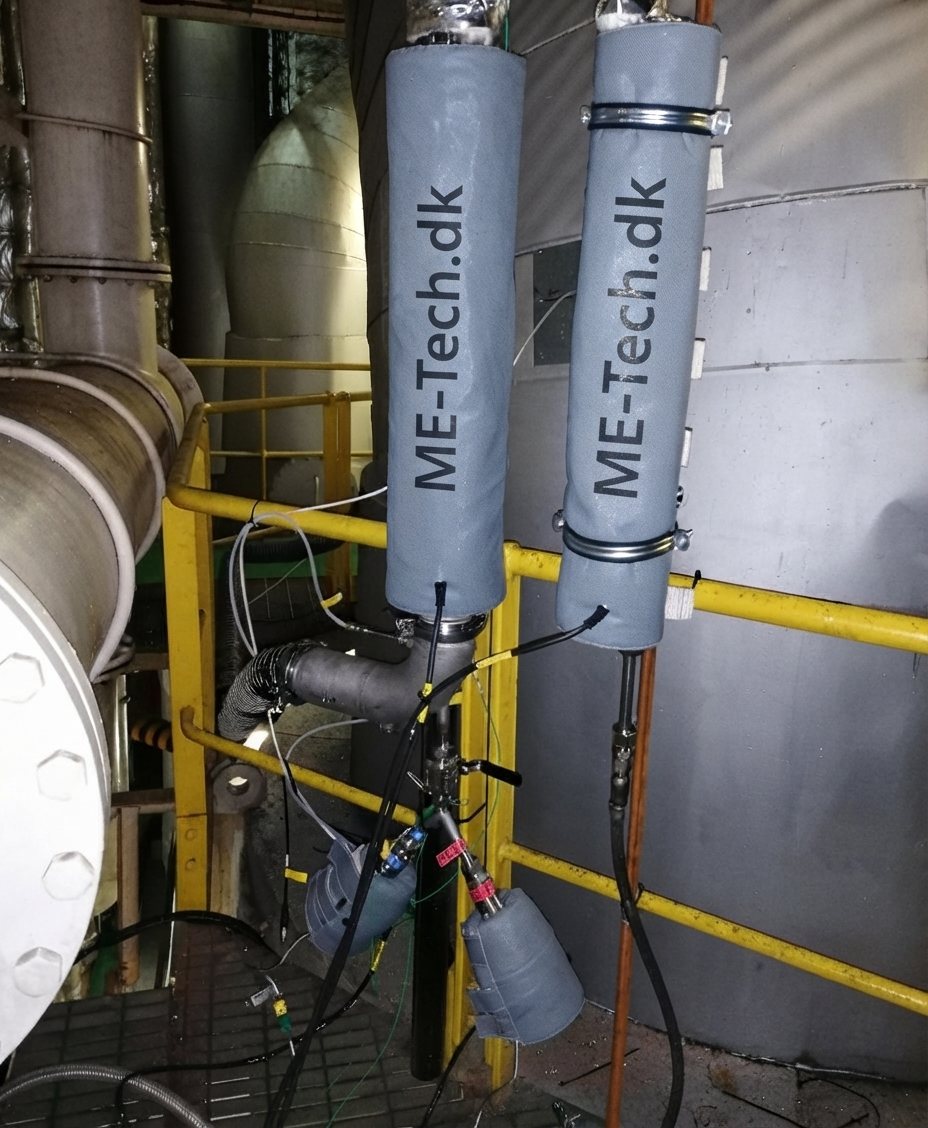 Insulated heated lines marked ME-Tech.dk at the exhaust funnel