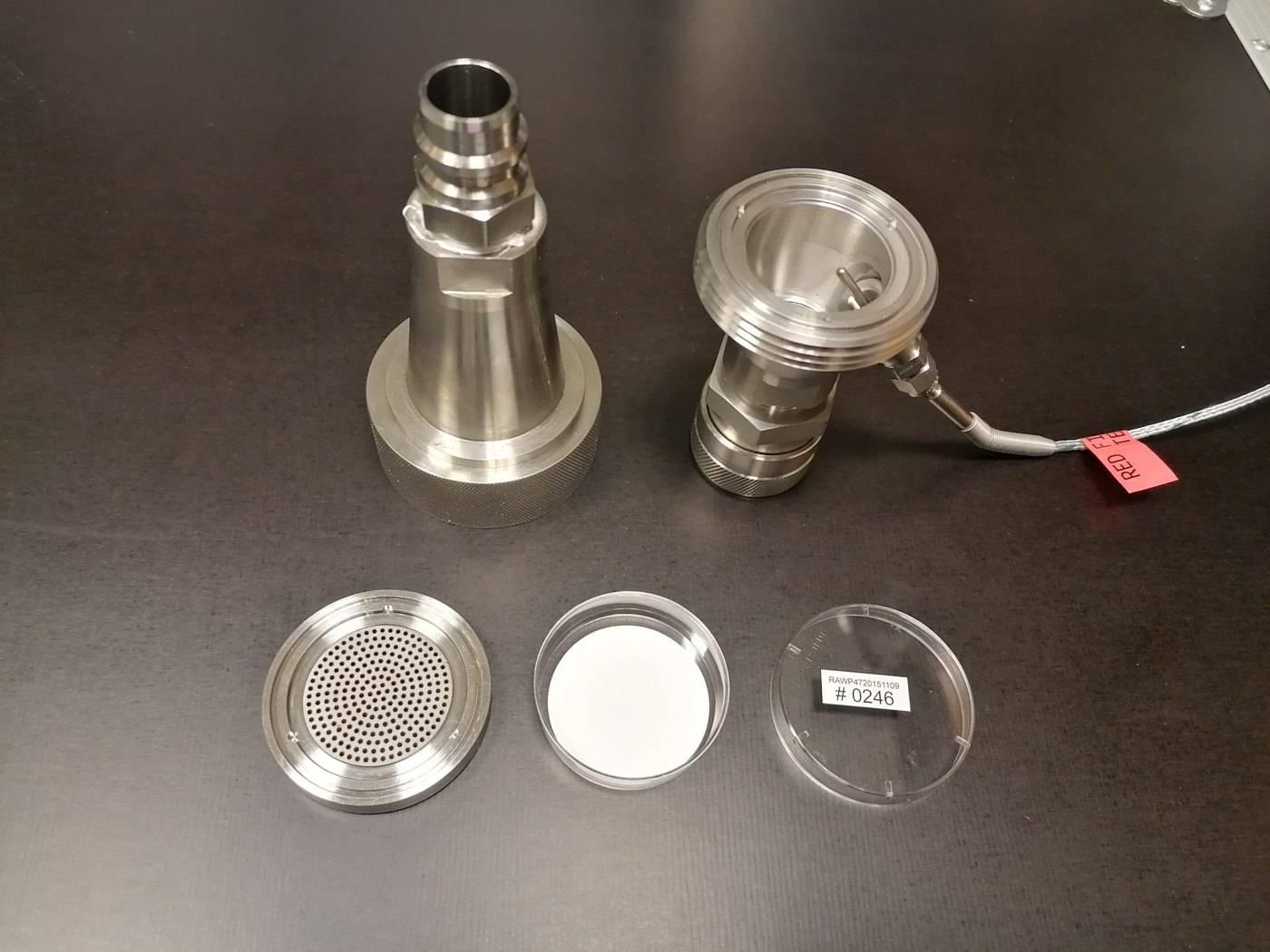 PM filter holder opened, with the filter in its dish